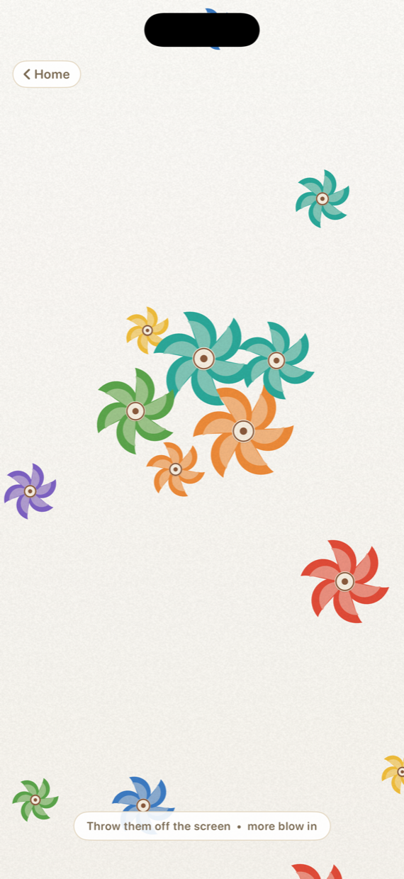Fan Flurry in Twirlio: a dozen small pinwheels in teal, orange, red, purple and yellow scattered across the screen, some clustered together and others drifting near the edges.